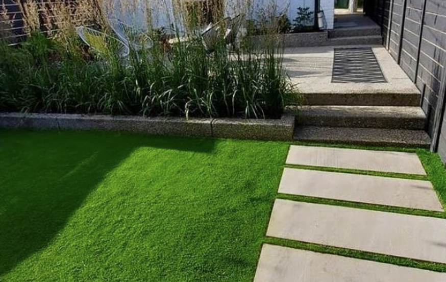 Pristine artificial turf installation in a backyard, offering a green lawn year-round.