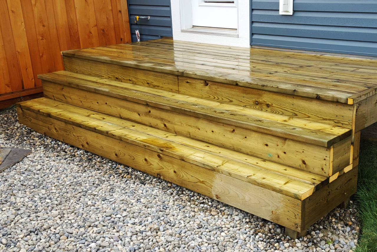 Large backyard deck with professional staining and strategic lighting
