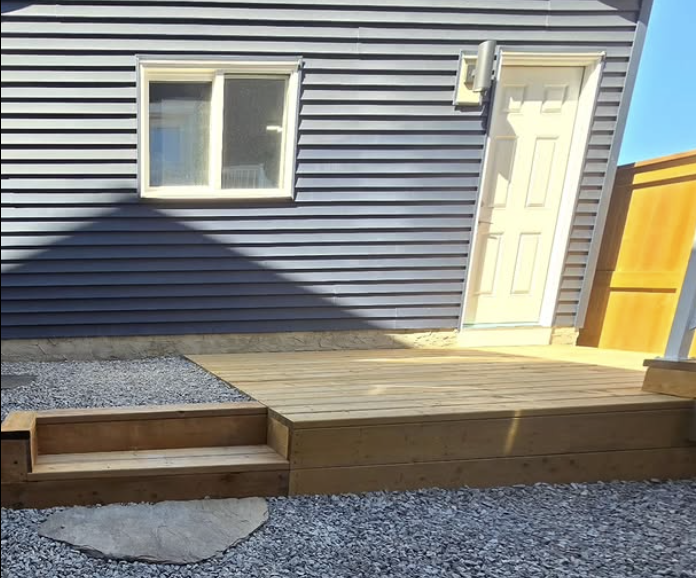 Custom wooden deck with beautiful railing and modern outdoor furniture