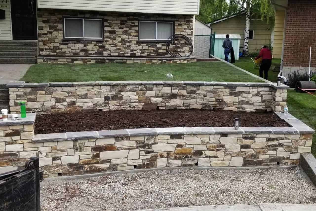Stone patio with matching retaining wall creating a cohesive outdoor space