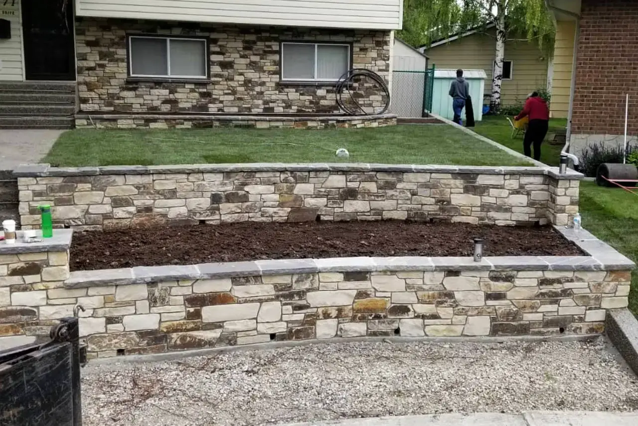 Stone patio with matching retaining wall creating a cohesive outdoor space