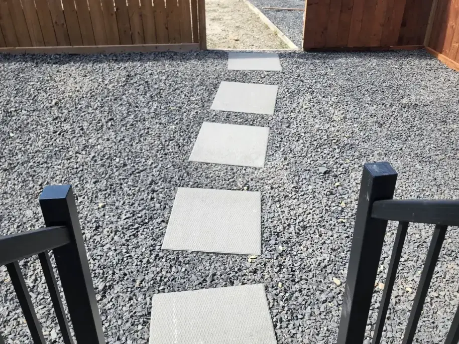 Stone pathway winding through garden with professional edging detail