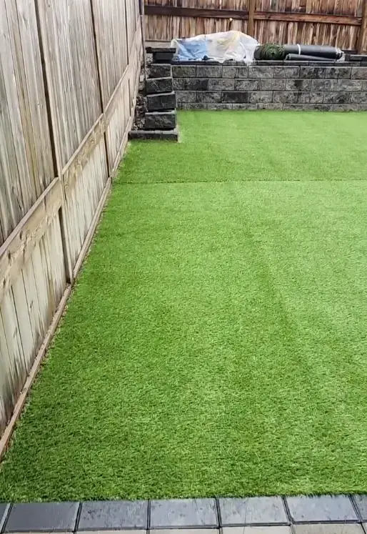 Vibrant green artificial turf installed for backyard sports and recreation area