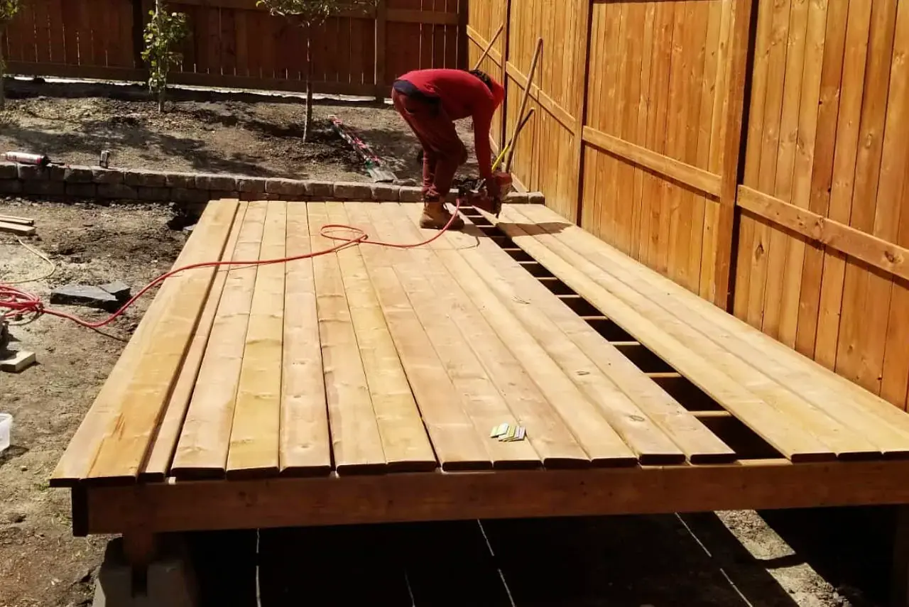 Multi-level wooden deck with integrated seating and stair design