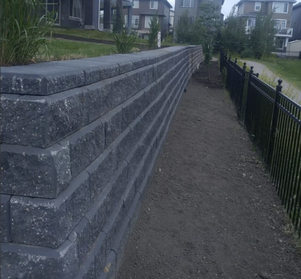 Professionally built stone retaining wall for a sloped Calgary yard